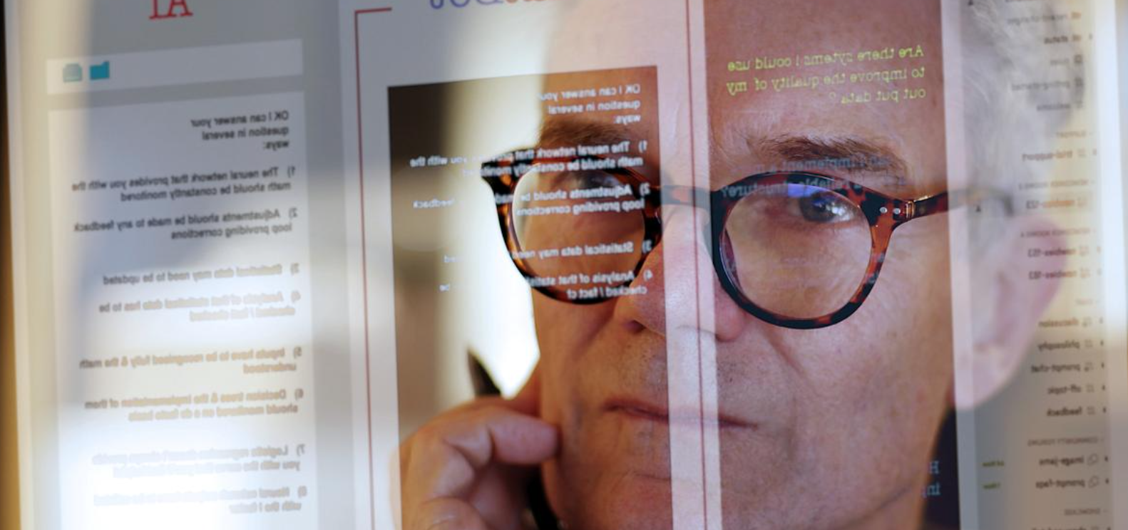 man in front of a computer screen